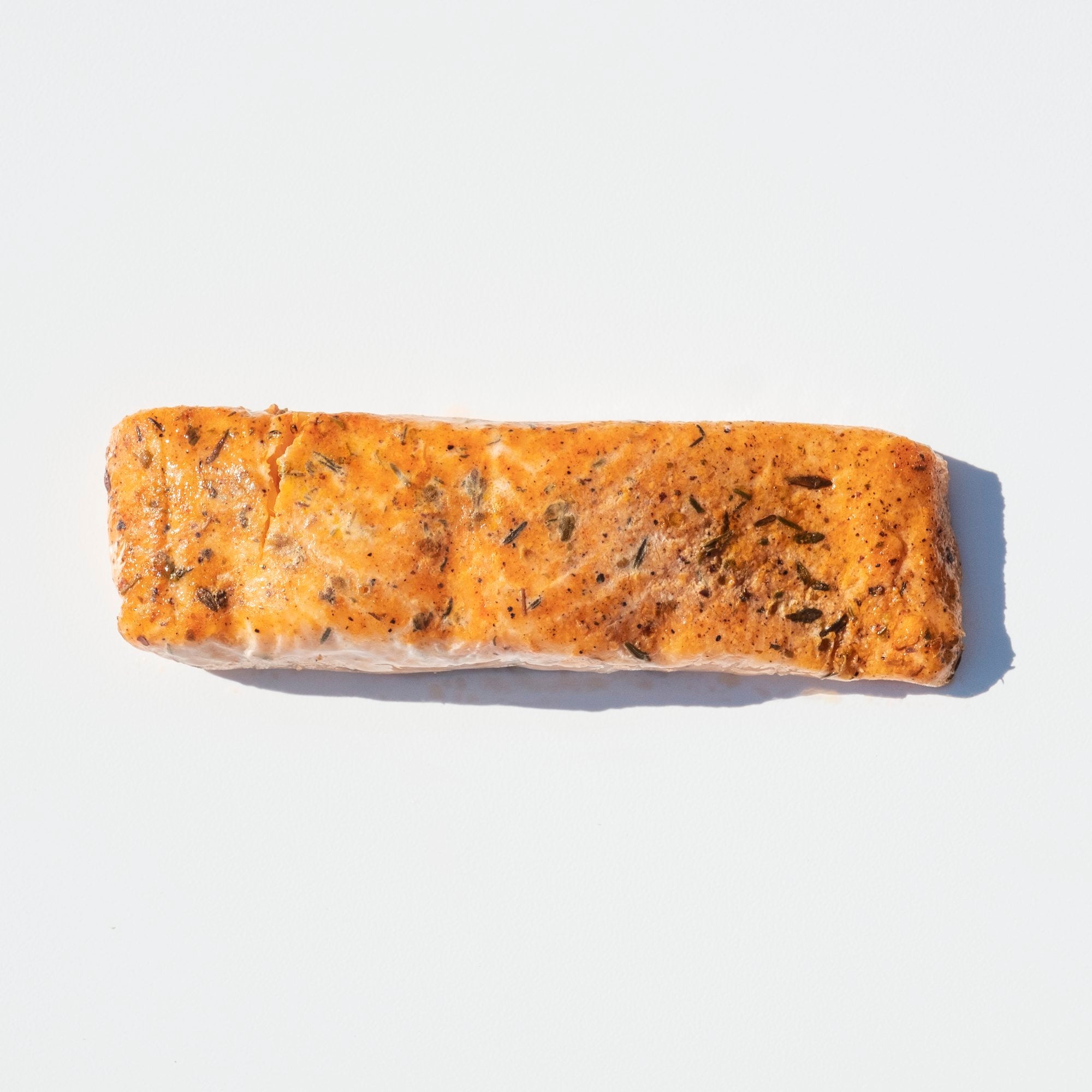 Frozen Skinless Lightly Blackened Atlantic Salmon Portions 10 Pound Each - 1 Per Case.