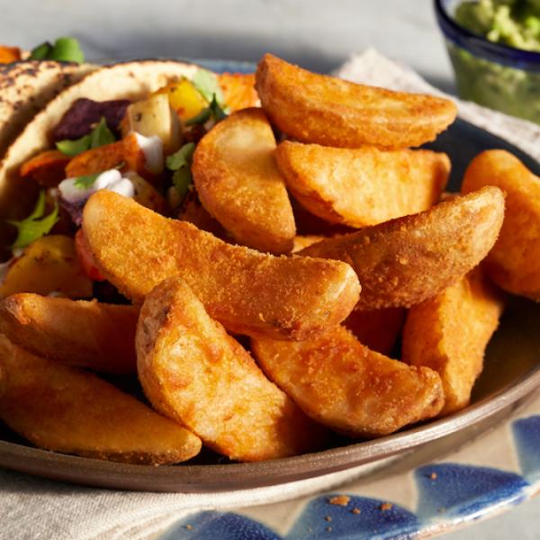 Lamb's Seasoned® Junior Wedge Cut Originalrecipe Frozen Potatoes 5 Pound Each - 6 Per Case.